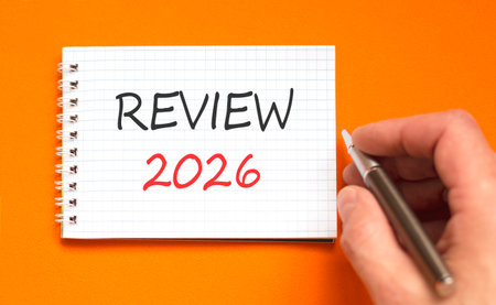Review 2026 symbol. Concept words Review 2026 on beautiful white note. Beautiful orange paper...