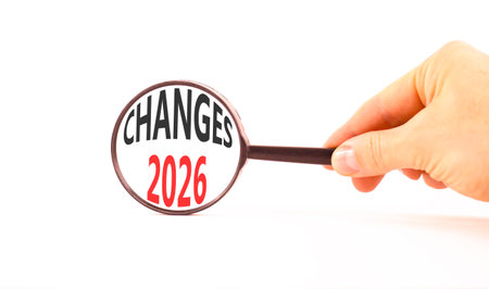 Changes 2026 symbol. Concept words Changes 2026 on beautiful white paper. Black magnifying glass....