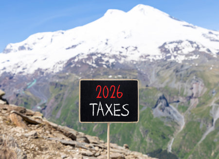 2026 taxes new year symbol. Concept words 2026 taxes on beautiful black blackboard. Beautiful mountain Elbrus and blue sky background. Business and 2026 taxes new year concept. Copy space.の写真素材