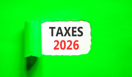 Taxes 2026 new year symbol. Concept words Taxes 2026 on beautiful white paper. Beautiful green paper background. Business and taxes 2026 new year concept. Copy space.の写真素材
