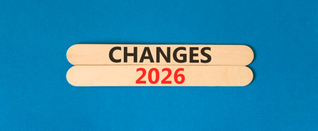 Changes 2026 symbol. Concept words Changes 2026 on beautiful wooden sticks. Beautiful blue paper background. Business and changes 2026 concept. Copy space.の写真素材