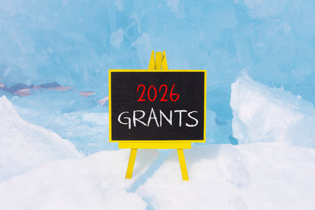2026 Grants symbol. Concept words 2026 Grants on beautiful black blackboard. Beautiful blue lake...