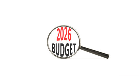 2026 Budget symbol. Concept words 2026 Budget on beautiful white paper. Black magnifying glass. Beautiful white paper background. Business and 2026 budget concept. Copy space.の写真素材