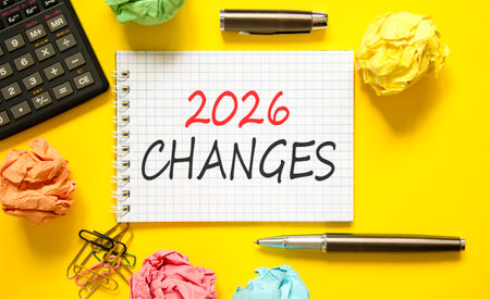 2026 Changes symbol. Concept words 2026 Changes on beautiful white note. Beautiful yellow paper background. Beautiful black pen, calculator. Business and 2026 changes concept. Copy space.の写真素材
