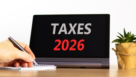 Taxes 2026 new year symbol. Concept words Taxes 2026 on beautiful black tablet screen. Beautiful...