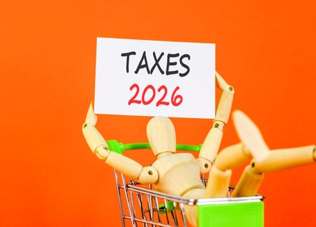 Taxes 2026 new year symbol. Concept words Taxes 2026 on beautiful white card. Beautiful orange paper...
