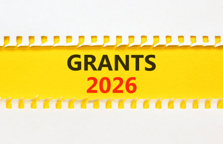 Grants 2026 symbol. Concept words Grants 2026 on beautiful yellow paper. Beautiful white paper background. Business and grants 2026 concept. Copy space.の写真素材