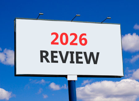 2026 Review symbol. Concept words 2026 Review on beautiful big white billboard. Beautiful blue sky and clouds background. Business and 2026 review concept. Copy space.の写真素材