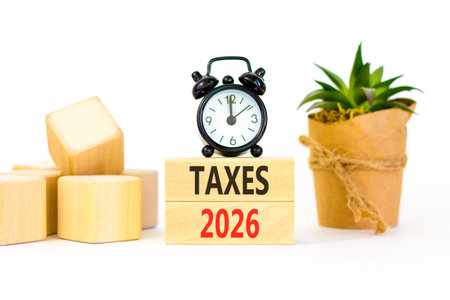 Taxes 2026 new year symbol. Concept words Taxes 2026 on beautiful wooden blocks. Beautiful white...
