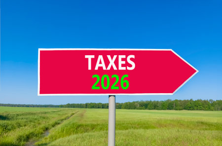 Taxes 2026 new year symbol. Concept words Taxes 2026 on beautiful red road sign. Beautiful green...