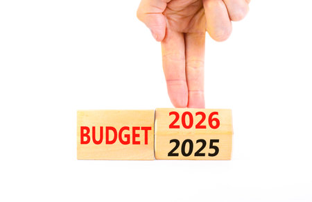 2026 Budget symbol. Concept words 2026 Budget on beautiful wooden blocks. Beautiful white paper background. Businessman's hand. Business and 2026 budget concept. Copy space.の写真素材