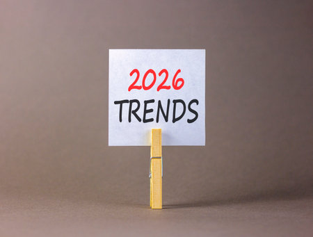 2026 Trends new year symbol. Concept words 2026 Trends on beautiful white paper on wooden clothespin. Beautiful gray background. Business and 2026 Trends new year concept. Copy space.の写真素材
