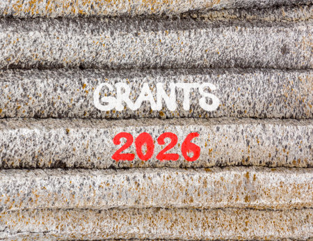 Grants 2026 symbol. Concept words Grants 2026 on beautiful gray mountain wall. Beautiful gray...