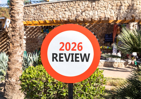 2026 Review symbol. Concept words 2026 Review on beautiful white and red road sign. Beautiful palm trees palm-trees background. Business and 2026 review concept. Copy space.の写真素材