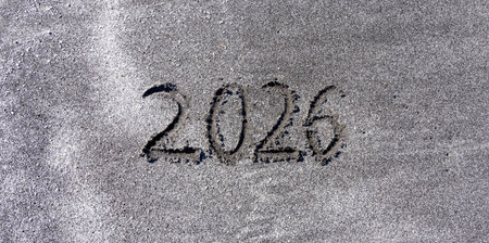 Business concept of 2026 new year symbol. Concept 2026 happy new year written on beautiful ocean sand beach. Beautiful ocean sand beach background, copy space. Business 2026 happy new year concept.の写真素材