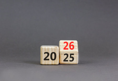 Business concept of 2026 new year symbol. Beautiful turned wooden cube and changed number 2025 to...