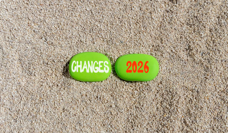 Changes 2026 symbol. Concept words Changes 2026 on beautiful green stones on sand beach. Beautiful...