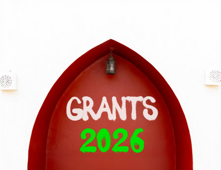 Grants 2026 symbol. Concept words Grants 2026 on beautiful white and red wall. Beautiful white and...