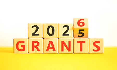 2026 Grants symbol. Concept words 2026 Grants on beautiful wooden blocks. Beautiful white and yellow paper background. Business and 2026 grants concept. Copy space.の写真素材