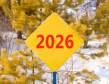 Business concept of 2026 new year symbol. Concept number 2026 Happy new year on beautiful yellow road sign. Beautiful winter forest background. Business 2026 happy new year concept. Copy space.の写真素材