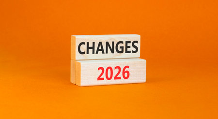 Changes 2026 symbol. Concept words Changes 2026 on beautiful wooden blocks. Beautiful orange paper background. Business and changes 2026 concept. Copy space.の写真素材
