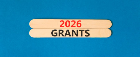 2026 Grants symbol. Concept words 2026 Grants on beautiful wooden sticks. Beautiful blue paper background. Business and 2026 grants concept. Copy space.の写真素材