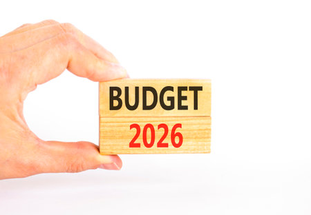Budget 2026 symbol. Concept words Budget 2026 on beautiful wooden blocks. Beautiful white paper background. Businessman's hand. Business and budget 2026 concept. Copy space.の写真素材