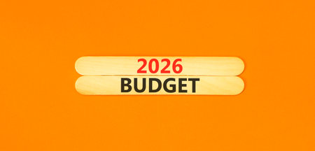2026 Budget symbol. Concept words 2026 Budget on beautiful wooden sticks. Beautiful orange paper background. Business and 2026 budget concept. Copy space.の写真素材
