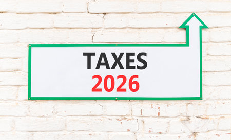 Taxes 2026 new year symbol. Concept words Taxes 2026 on beautiful white sign with arrow. Beautiful...