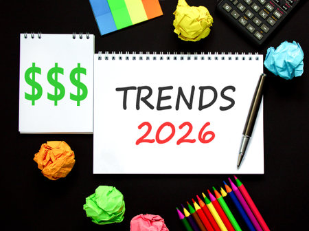 Trends 2026 new year symbol. Concept words Trends 2026 on beautiful white note. Beautiful black paper background. Beautiful black pen, calculator. Business Trends 2026 new year concept. Copy space.の写真素材