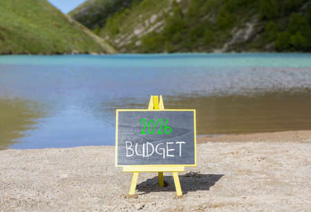 2026 Budget symbol. Concept words 2026 Budget on beautiful black blackboard. Beautiful mountain lake sand beach background. Business and 2026 budget concept. Copy space.の写真素材
