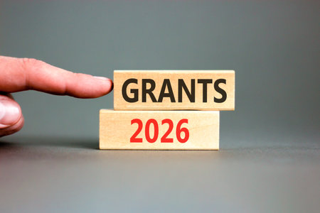 Grants 2026 symbol. Concept words Grants 2026 on beautiful wooden blocks. Beautiful gray paper...