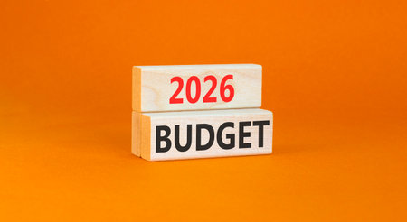 2026 Budget symbol. Concept words 2026 Budget on beautiful wooden blocks. Beautiful orange paper background. Business and 2026 budget concept. Copy space.の写真素材