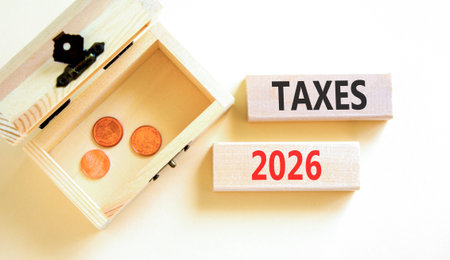 Taxes 2026 new year symbol. Concept words Taxes 2026 on beautiful wooden blocks. Beautiful white...