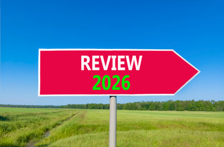 Review 2026 symbol. Concept words Review 2026 on beautiful red road sign. Beautiful green grass...