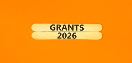 Grants 2026 symbol. Concept words Grants 2026 on beautiful wooden sticks. Beautiful orange paper...