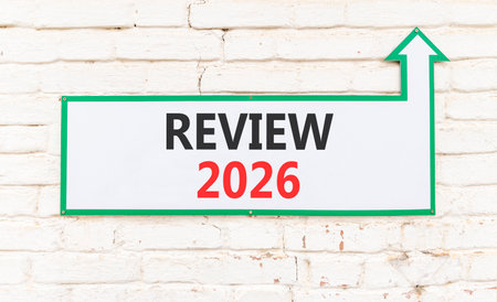 Review 2026 symbol. Concept words Review 2026 on beautiful white paper. Beautiful yellow paper background. Business and review 2026 concept. Copy space.の写真素材