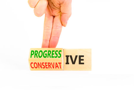 Progressive or conservative symbol. Businessman turns wooden cubes and changes the word Conservative...