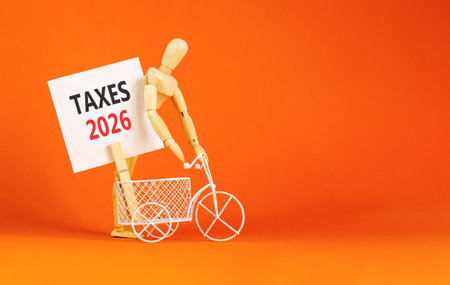 Taxes 2026 new year symbol. Concept words Taxes 2026 on beautiful white card. Beautiful orange paper background. Businessman's model. Business and taxes 2026 new year concept. Copy space.の写真素材