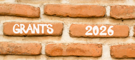 Grants 2026 symbol. Concept words Grants 2026 on beautiful brown brick wall. Beautiful brown brick...