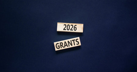 2026 Grants symbol. Concept words 2026 Grants on beautiful wooden blocks. Beautiful black paper background. Business and 2026 grants concept. Copy space.の写真素材