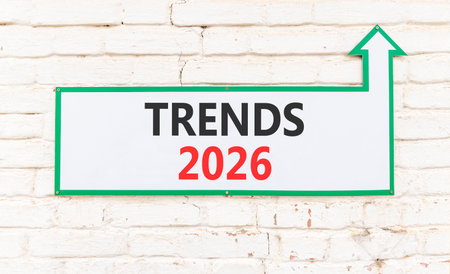 Trends 2026 new year symbol. Concept words Trends 2026 on beautiful white sign with arrow. Beautiful old white brick wall background. Business and Trends 2026 new year concept. Copy space.の写真素材