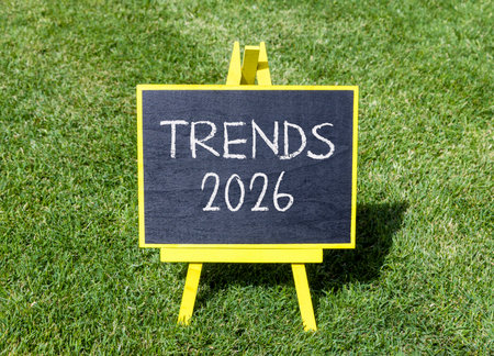 Trends 2026 new year symbol. Concept words Trends 2026 on beautiful black blackboard. Beautiful green grass background. Business and Trends 2026 new year concept. Copy space.の写真素材