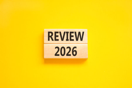 Review 2026 symbol. Concept words Review 2026 on beautiful wooden blocks. Beautiful yellow paper...