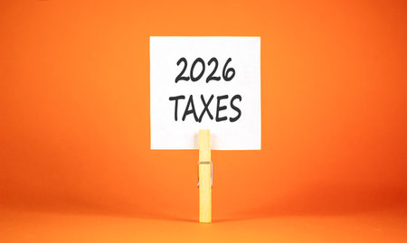 2026 taxes new year symbol. Concept words 2026 taxes on beautiful white paper on wooden clothespin....
