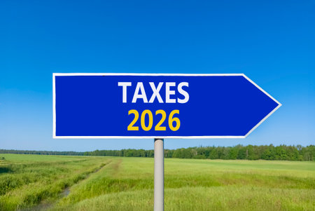 Taxes 2026 new year symbol. Concept words Taxes 2026 on beautiful blue road sign. Beautiful green...