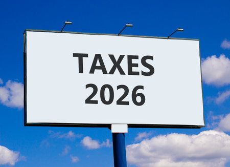 Taxes 2026 new year symbol. Concept words Taxes 2026 on beautiful big white billboard. Beautiful blue sky and clouds background. Business and taxes 2026 new year concept. Copy space.の写真素材