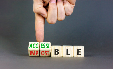 Accessible or impossible symbol. Concept words Accessible or Impossible on beautiful wooden blocks. Beautiful gray table gray background. Business accessible or impossible concept. Copy space.の写真素材