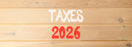 Taxes 2026 new year symbol. Concept words Taxes 2026 on beautiful wooden wall. Beautiful wooden wall background. Business and taxes 2026 new year concept. Copy space.の写真素材