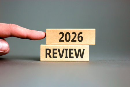 2026 Review symbol. Concept words 2026 Review on beautiful wooden blocks. Beautiful gray paper...